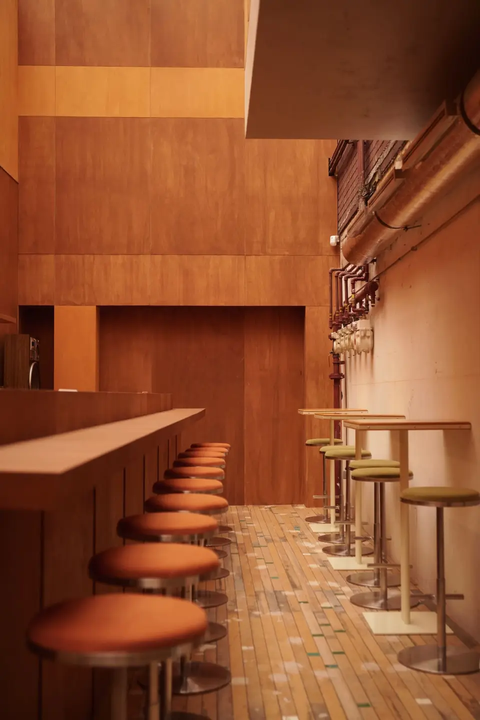 Interior with a long counter and orange stools