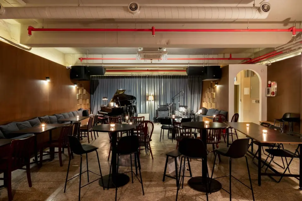 Dark lounge interior with a small stage